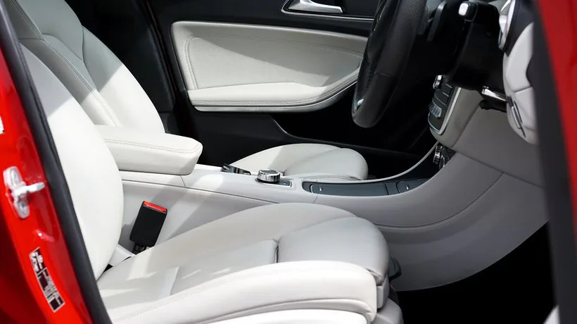 Cleaning a car seat to remove greasy sun cream marks