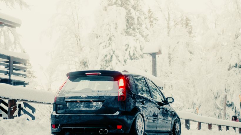 A car on a salted, snowy winter road