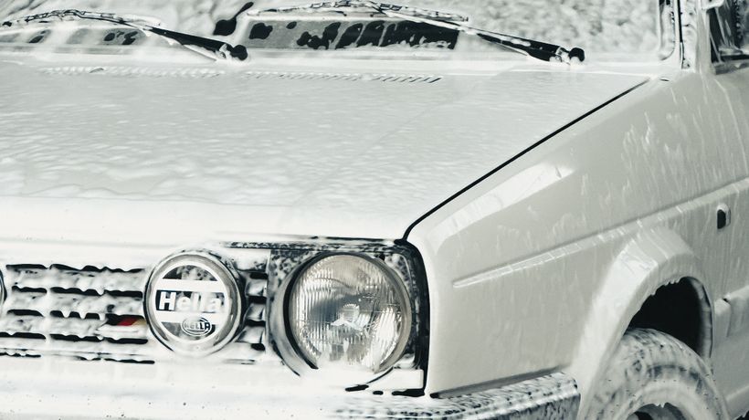 A car being washed at a static car wash