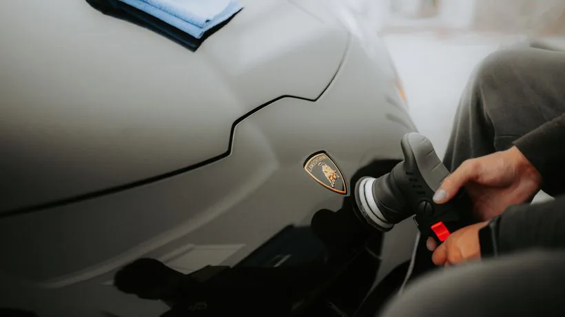 Spraying a quick detailer to refresh a car's shine between washes